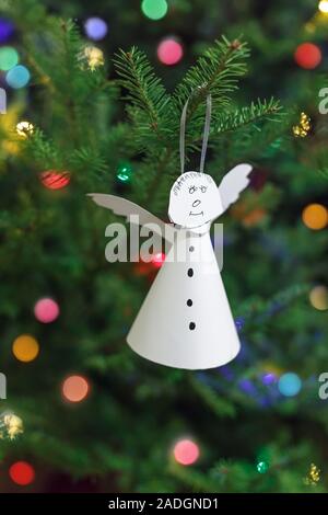 Angel made of white paper, hanging on Christmas tree. Easy DIY Stock Photo