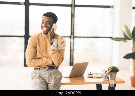 Happy black businessman talking on the phone Stock Photo