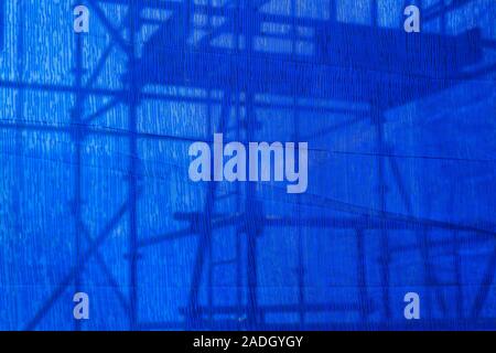 blue canvas covering the building Under construction Stock Photo