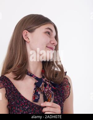 Smiling girl in summer dress in profile on a white background Stock Photo