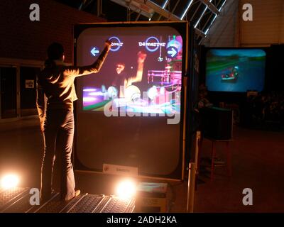 Virtual reality exhibition display stands. Visitor interacting with a virtual reality display. Virtual reality (VR) is where a person interacts with a Stock Photo