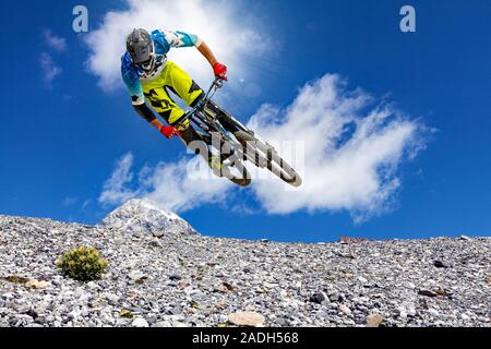 downhill biker in the high mountains Stock Photo