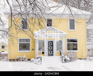 Traditional older family home covered in snow. Stock Photo