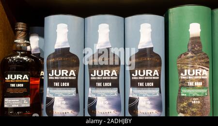 Jura malt whisky display in airport duty free shop.