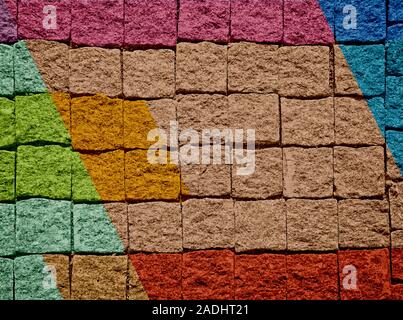 Brick wall texture with paint painted stylish street art design. Abstract multicolor urban graffiti. Stock Photo