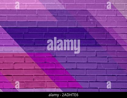 Brick wall texture with paint painted stylish street art design. Abstract multicolor urban graffiti. Stock Photo