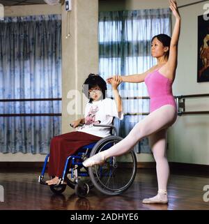 Wheelchair user teaching ballet. Photographed in Malaysia. Stock Photo