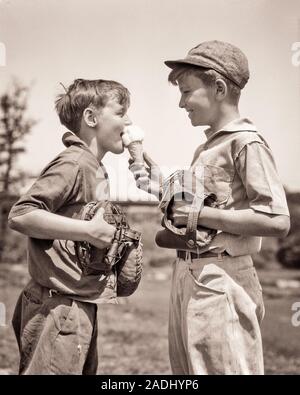 1930s TWO BOYS HOLDING BASEBALL GLOVES AND CATCHER’S MASK SHARING AN ICE CREAM CONE - f4327 HAR001 HARS TEAMWORK PLEASED JOY LIFESTYLE BROTHERS RURAL CONE HEALTHINESS HOME LIFE COPY SPACE FRIENDSHIP HALF-LENGTH MALES SIBLINGS SHARE B&W SUMMERTIME HAPPINESS CHEERFUL AND NUTRITION RECREATION AN SIBLING SMILES CONNECTION CONSUME CONSUMING JOYFUL NOURISHMENT ICE CREAM BALL GAME BALL SPORT COOPERATION GROWTH JUVENILES PRE-TEEN PRE-TEEN BOY SEASON TOGETHERNESS BASEBALL BAT BLACK AND WHITE CAUCASIAN ETHNICITY HAR001 OLD FASHIONED Stock Photo
