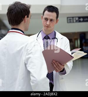 Hospital doctors discussing a patient's notes. Stock Photo