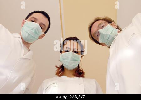 MODEL RELEASED. Three doctors wearing face masks. Stock Photo