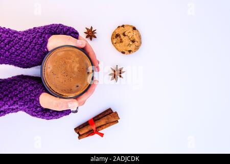 Female hands holding hot chocolate  on a white background. Stock Photo
