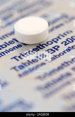 Trimethoprim antibiotic pill on its blister pack. Trimethoprim is primarily used to treat infections of the urinary tract. It works by inhibiting the Stock Photo