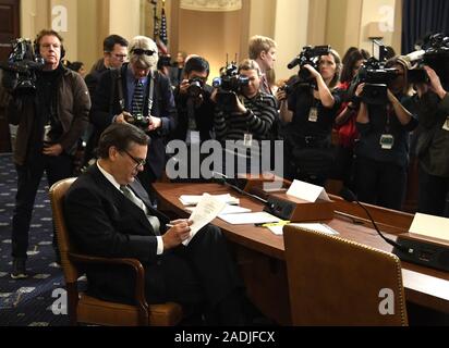 Washington, United States. 04th Dec, 2019.Washington DC, USA. 04th Dec, 2019.  Law Professor Jonathan Turley makes notes as he waits the start of the House Judiciary Committee hearings, as part of the Donald Trump impeachment inquiry, on Capitol Hill, Wednesday, December 4, 2019, in Washington, DC. Stock Photo