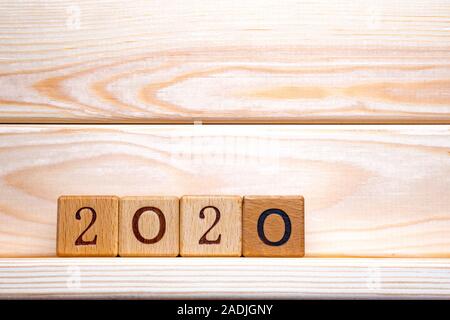 2020 new year greeting card template, 2020 on wooden cubes on wood table, banner with copy space for text. Copy space Stock Photo