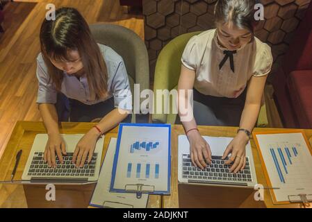 Top view of two business employees working late Stock Photo