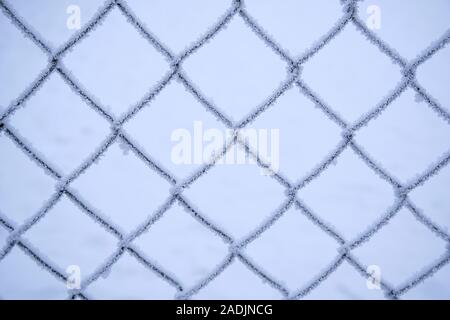 Mesh netting covered with frost after heavy fog and frost. Stock Photo