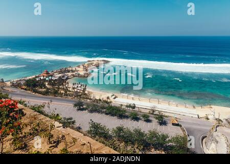 Beautiful view of Melasti Beach. Blue sea with waves, clear sky and white sand in Indian Ocean, South Kuta, Bali. Stock Photo