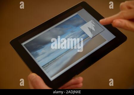 Retouching and editing a photograph on a tablet. Stock Photo