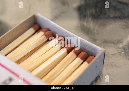 Close up macro shot of matchbox full of match sticks. Stock Photo