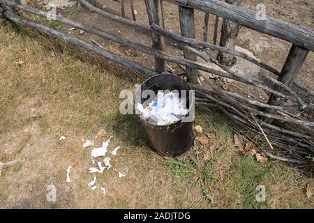 Public trash can full with garbage. Dirty city trash bin. Stock Photo
