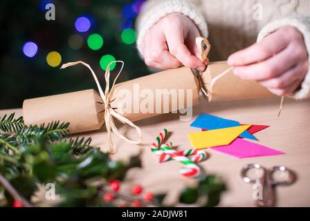 Close Up Of Woman Making Homemade Eco Friendly Christmas Cracker From Sustainable Materials Stock Photo