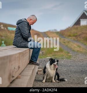 Man and his dog, Flatey Island, Breidafjordur, Westfjords, Iceland Stock Photo