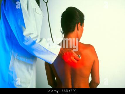Lung examination. General practice doctor listening to the lungs of a young woman. He is using a stethoscope, a device which amplifies sounds made by Stock Photo