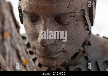 Umea, Norrland Sweden - October 22, 2019: artwork where statue hugs trees at Umedalen Stock Photo