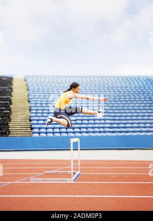 MODEL RELEASED. Airborne hurdler. Stock Photo