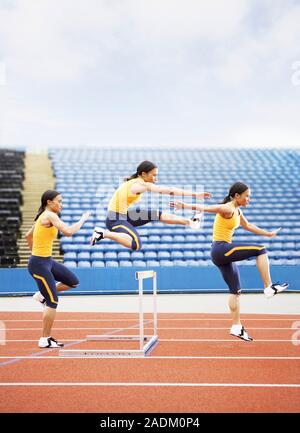 MODEL RELEASED. Hurdling. Composite high-speed photograph of an athlete executing a jump over a hurdle. This effect was achieved by photographing the Stock Photo