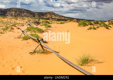 Partially buried split rail fence in Coral Pink Sand Dunes State Park near Kanab, Utah Stock Photo