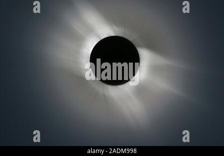 Total solar eclipse. Outer corona of the Sun, seen during a total solar eclipse. The corona is shaped by the Sun's magnetic field, with the magnetic p Stock Photo