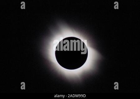 Total solar eclipse. Outer corona of the Sun, seen during a total solar eclipse. The corona is shaped by the Sun's magnetic field, with the magnetic p Stock Photo