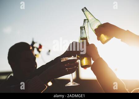 Daylight going through the glass. It's rooftop party. Group of friends have holidays at sunny autumn day Stock Photo