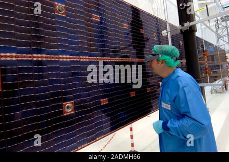 ISS supply vehicle solar panels. Technician using a head-worn magnifier to examine the solar panels for the European Space Agency's automated transfer Stock Photo