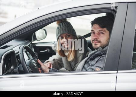 Ready for a journey. Nice couple have weekend at countryside at winter time Stock Photo