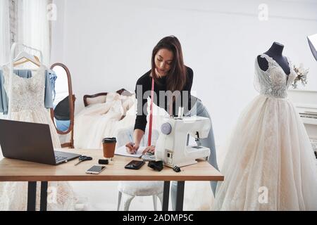 Modern room. Female fashion designer works on the new clothes in the workshop Stock Photo