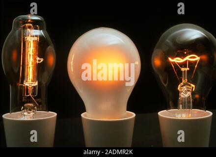 Three 100-Watt light bulbs. They are (left to right): halogen, pearl envelope and clear envelope. The halogen bulb has a tungsten filament surrounded Stock Photo