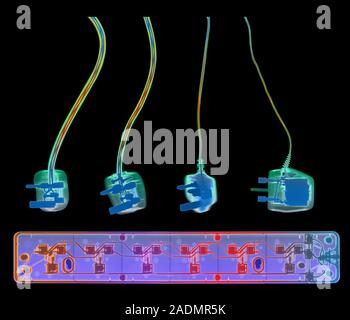 Electrical plugs and socket extension. Coloured X- ray of four 3-pin electrical plugs and a socket extension board. The plugs connect domestic applian Stock Photo