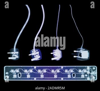 Electrical plugs and socket extension. Coloured X- ray of four 3-pin electrical plugs and a socket extension board. The plugs connect domestic applian Stock Photo