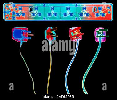 Electrical plugs and socket extension. Coloured X- ray of four 3-pin electrical plugs and a socket extension board. The plugs connect domestic applian Stock Photo