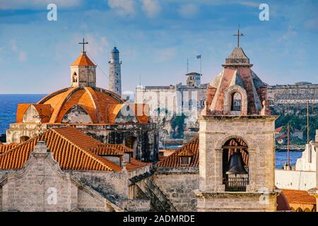 Top view over Havana with Cathedral de San Cristobal in the foreground and the fortress cabana and Morro castle in the background. Stock Photo