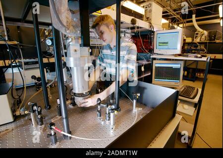 Flash photolysis. Researcher loading samples that will undergo flash photolysis, a method of investigating fast photochemical reactions. Exposure to v Stock Photo