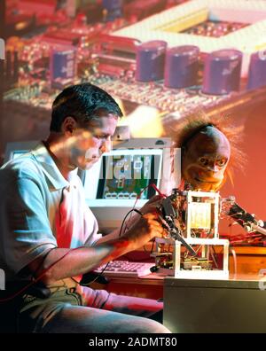 Steve Grand and Lucy. Steve Grand, the British artificial intelligence (AI) researcher, working on Lucy, his robot. Since May 2000, Lucy has been desi Stock Photo