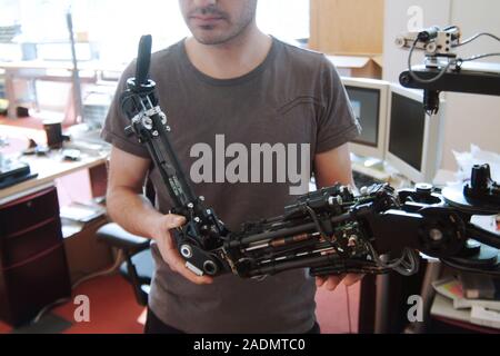 Robotics research. Student working with a robot at the Massachusetts Institute of Technology (MIT) AI Lab, Massachusetts, USA. The MIT AI (artificial Stock Photo