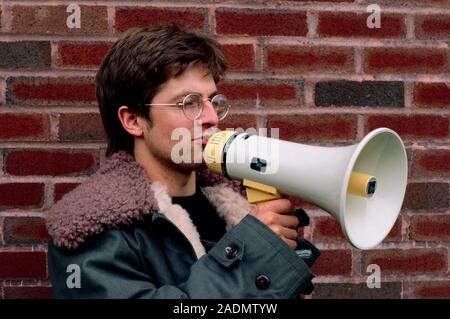 Man using a megaphone, or loud hailer. Stock Photo