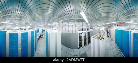 Mobile phone exchange. Technicians working in a mobile telephone network exchange centre. Stock Photo