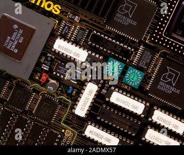Computer circuit board. Close-up view of the 'chips' on a modern computer circuit board. Each small, black 'chip' contains the equivalent of thousands Stock Photo