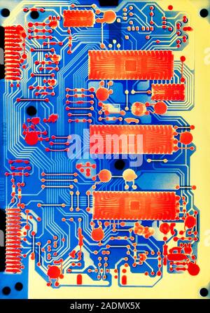 Circuit board. Coloured high-resolution X-ray of a circuit board. Circuit boards are comprised of individual components connected by electrical pathwa Stock Photo