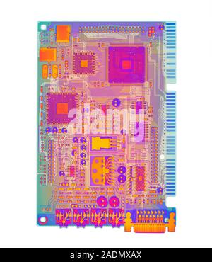 Sound card. Coloured X-ray of a sound card (or sound board), a printed circuit board. Among the electronic components attached to it are micro- chips Stock Photo